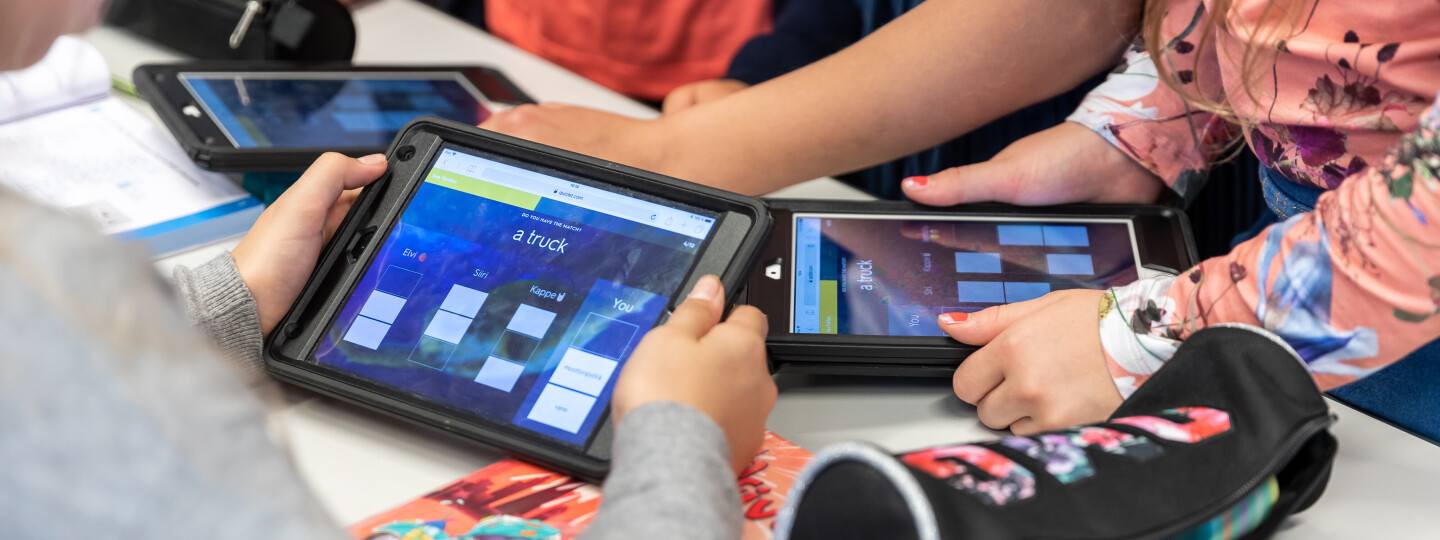 Children's hands holding tablets