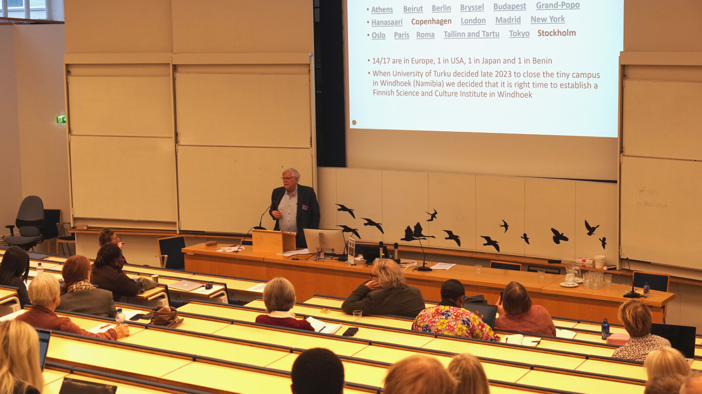 Audience in a lecture hall listening to a speaker