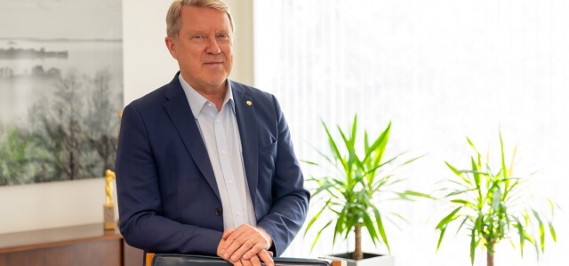 Rehtori Jukka Kola hymyilee työhuoneessaan