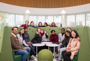 A group of students sitting on and around a couch